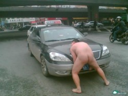 Nude Chinese man holding up an Anhui taxi