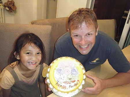 A 2013 photo of Ray Wigdal and Phoebe celebrating a birthday together. Photo source:  rayschildren.org.